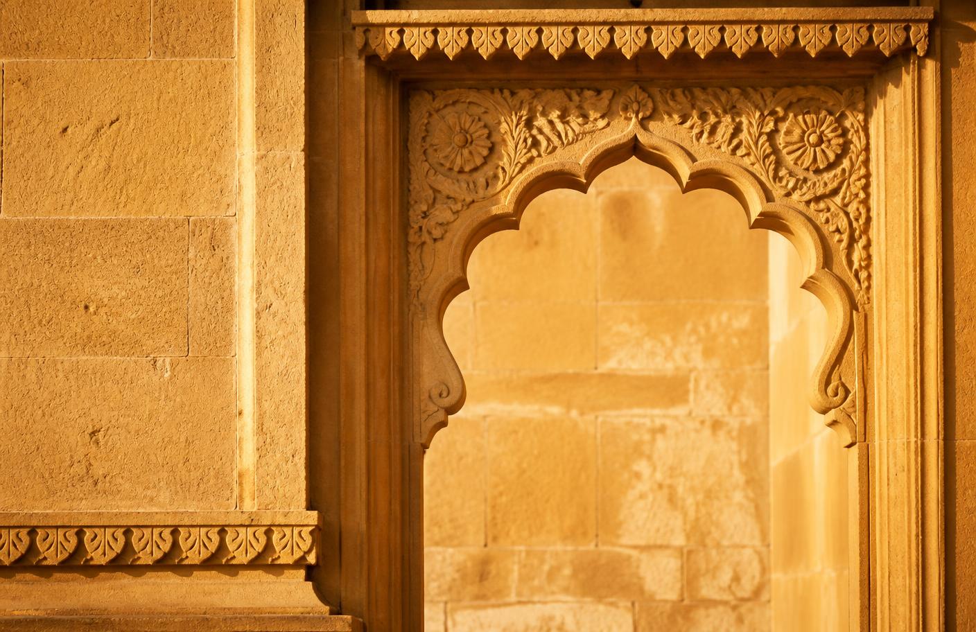 Carved golden sandstone arch detail typical of Jodhpur architecture in late afternoon light